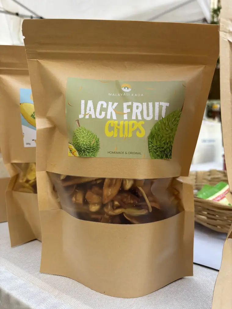 Kraft pouch of jackfruit chips with a Malayali Kada label at a stall